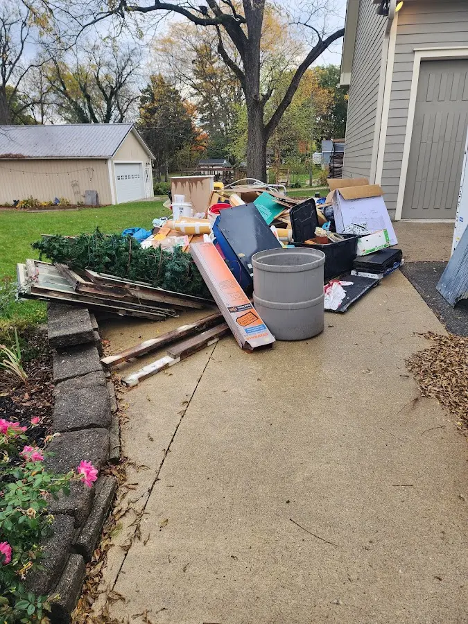 Dumpster being loaded with debris for Residential Dumpster Rental in Garnet